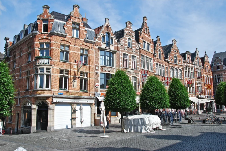 a row of red bricked houses with lots of windows