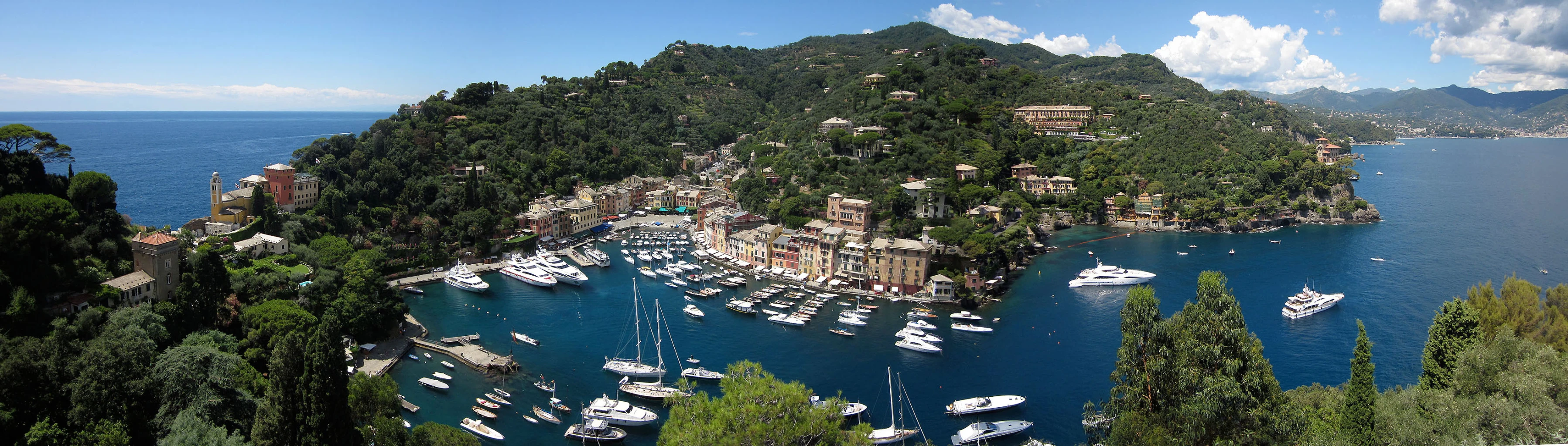 an island with several boats floating in it and on the ocean