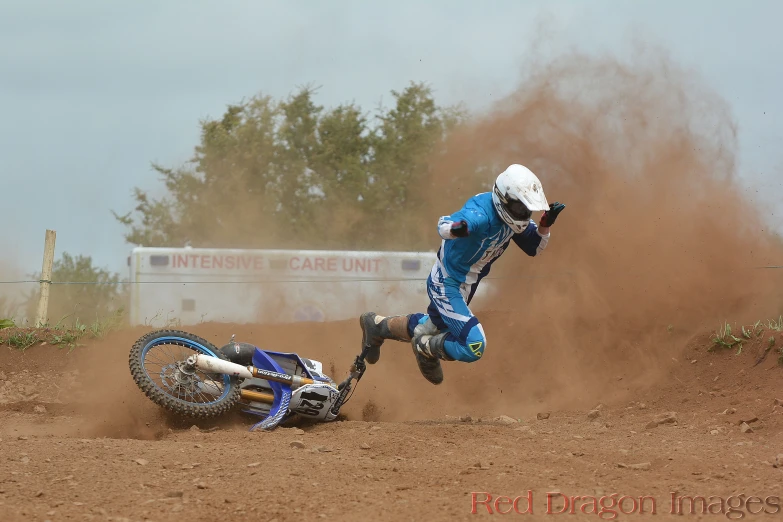 the motocross rider is trying to do a jump on his bike