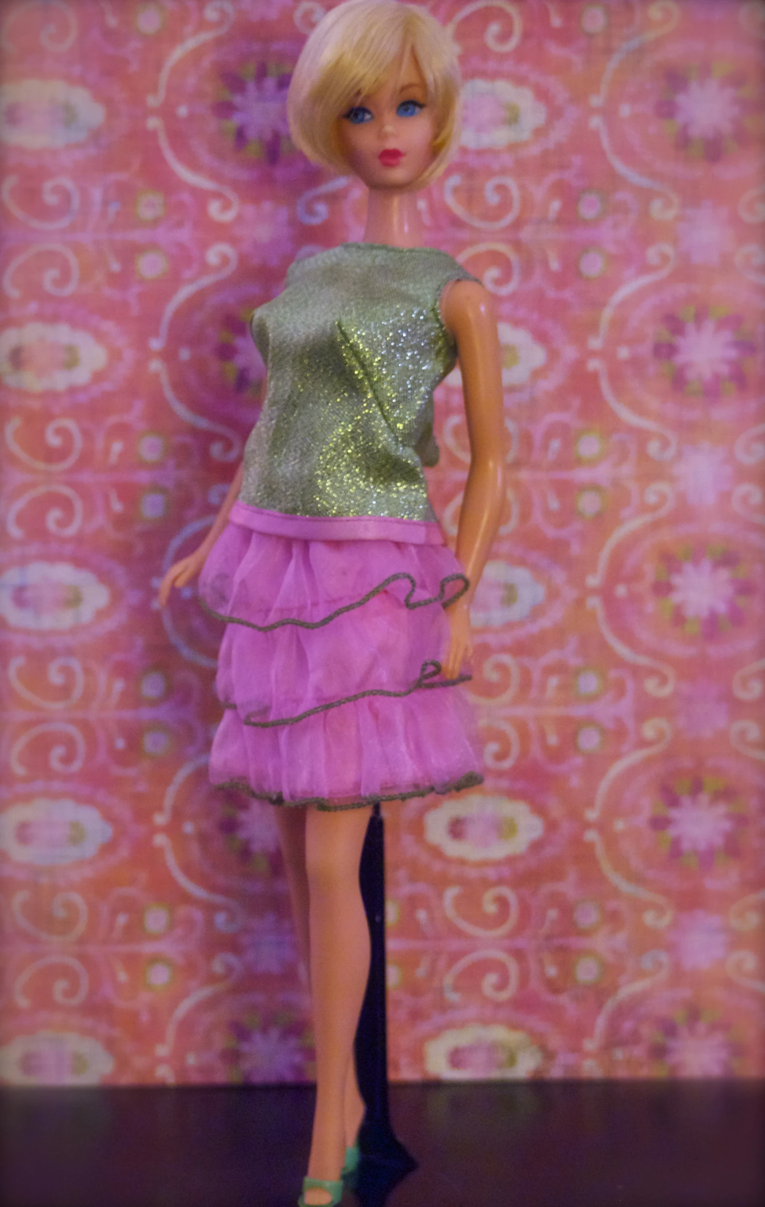 a barbie doll with short hair and purple dress