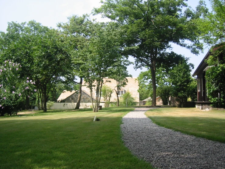 a stone walkway leads to a small garden