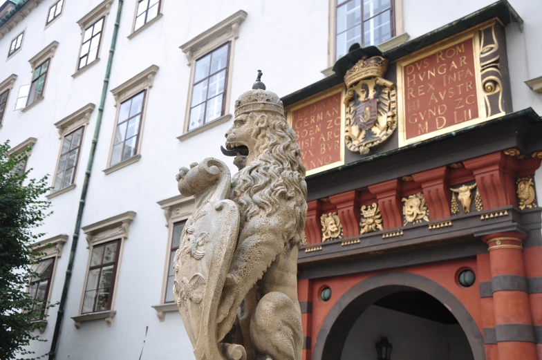 the sculpture is in front of the entrance of the building