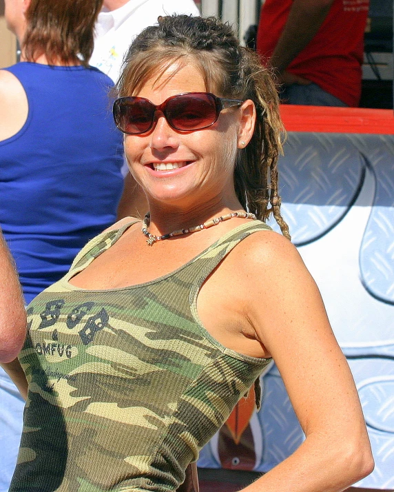 a woman wearing sunglasses posing for the camera