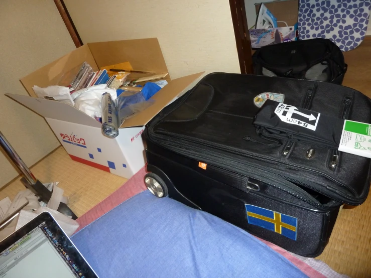 a suitcase and computer with a sticker on it