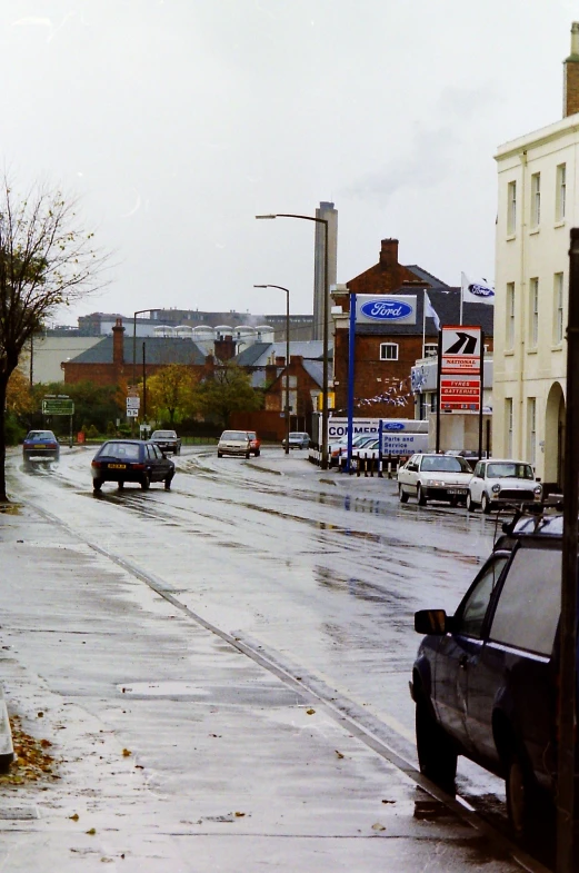 a street filled with cars and surrounded by buildings