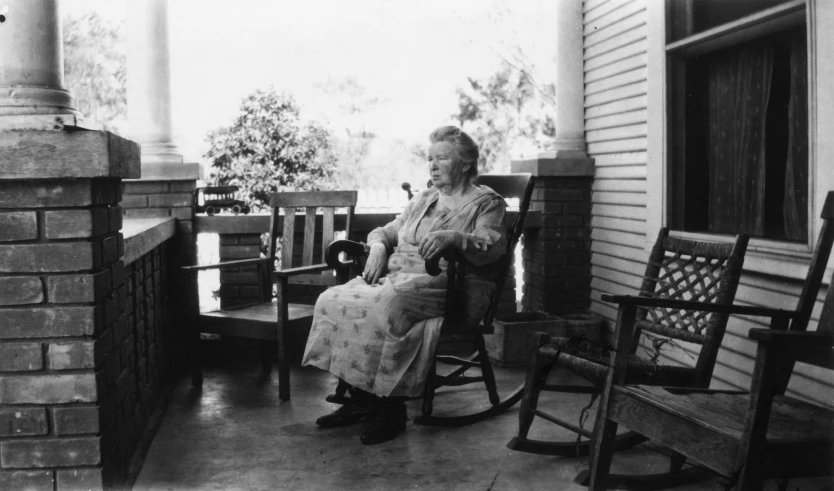 black and white po of an older woman on the porch