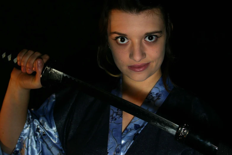 a girl holding a sword with dark eyes