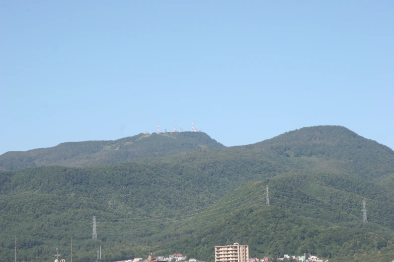 an island is surrounded by mountains and buildings