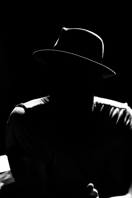 a black and white po of a man in a hat