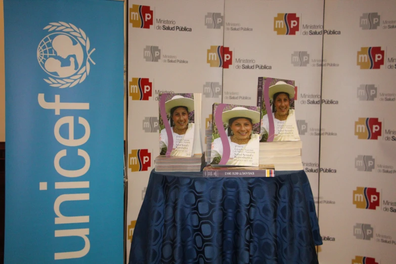 three men at a table with three hats