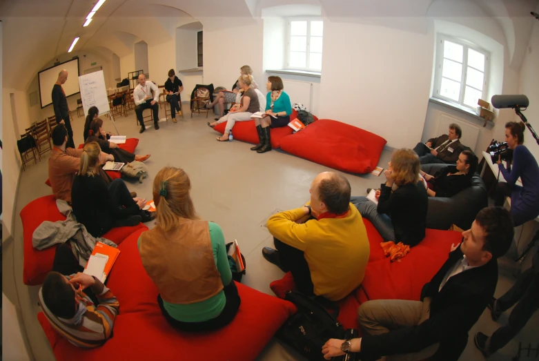 people seated on bean bags in an open room