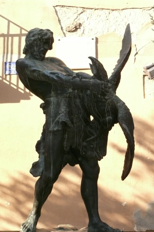 the statue has a giant bird on his back
