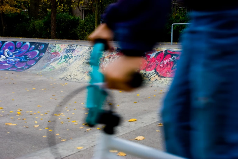 a person on a bicycle is near a wall with graffiti