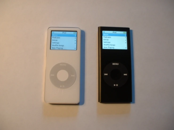 an ipod and an mp3 player are lined up on the table