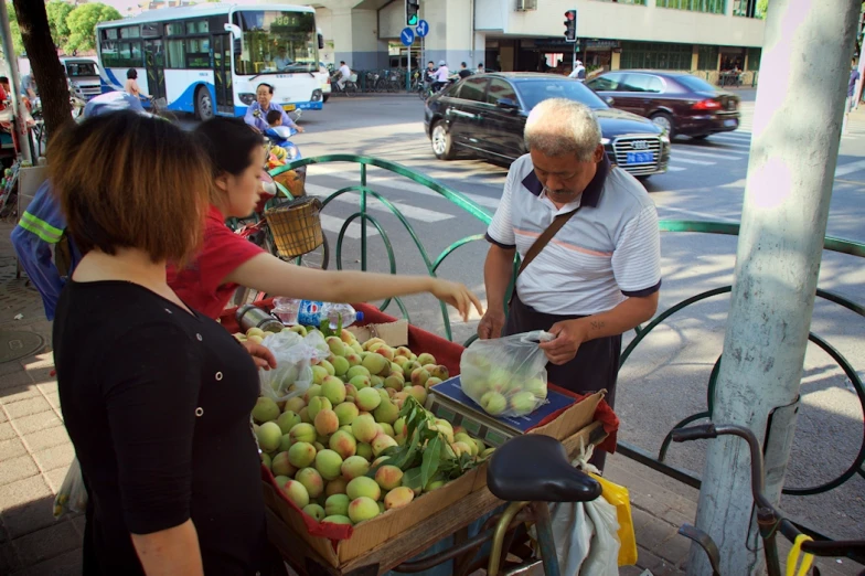 the old man is hing his cart full of fruit