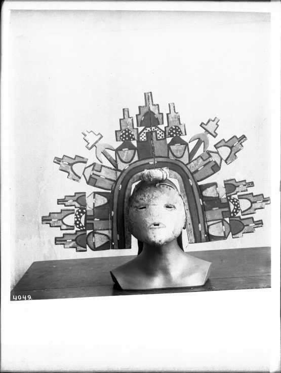 a black and white po of a woman's head, with decorative objects on the back