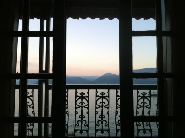 the view out a window of some buildings and a lake