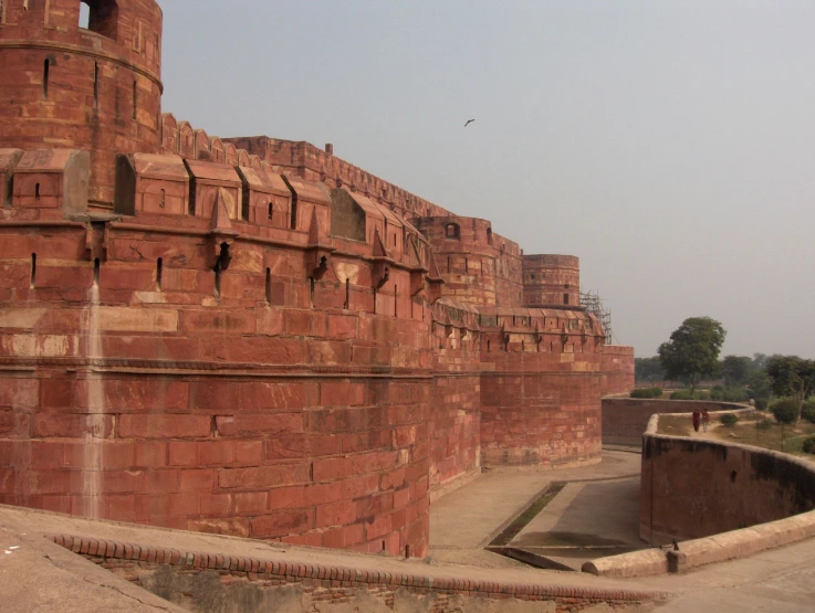 two very tall red brick structures by the road