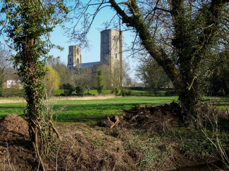 an old church spire in the distance from the ground