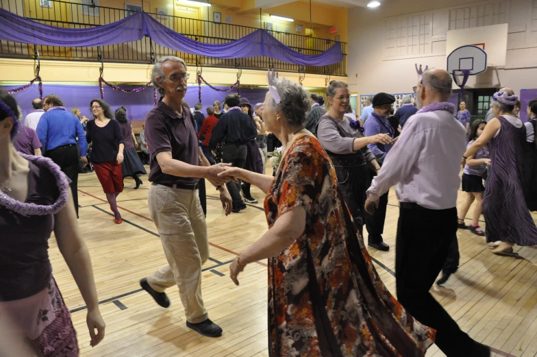 several adults and children dancing at a party