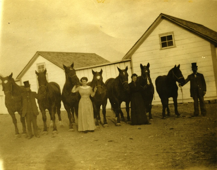 an old po shows a woman surrounded by horses