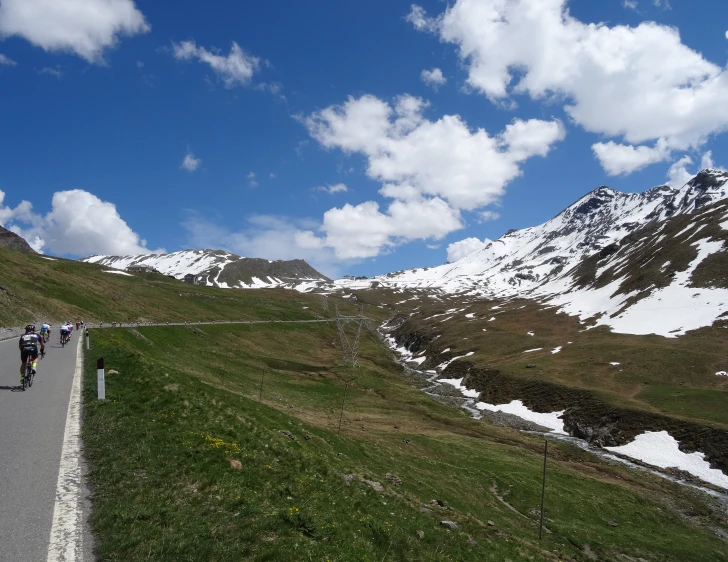 group of bikers riding down the winding road