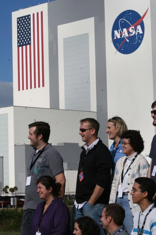 several nasa astronauts are standing in line outside the space station