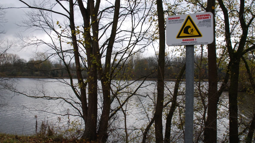 a street sign that is posted in front of trees