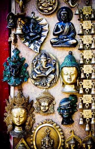 decorative wall hanging with a variety of buddha and angel faces