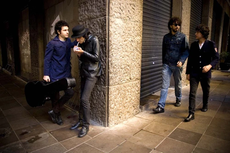 a group of men standing around a tall building