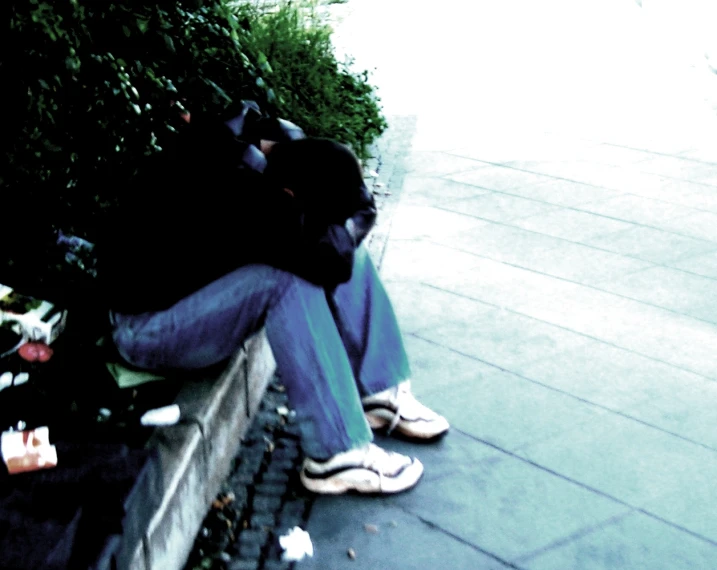 a person sitting on a bench wearing a cat mask