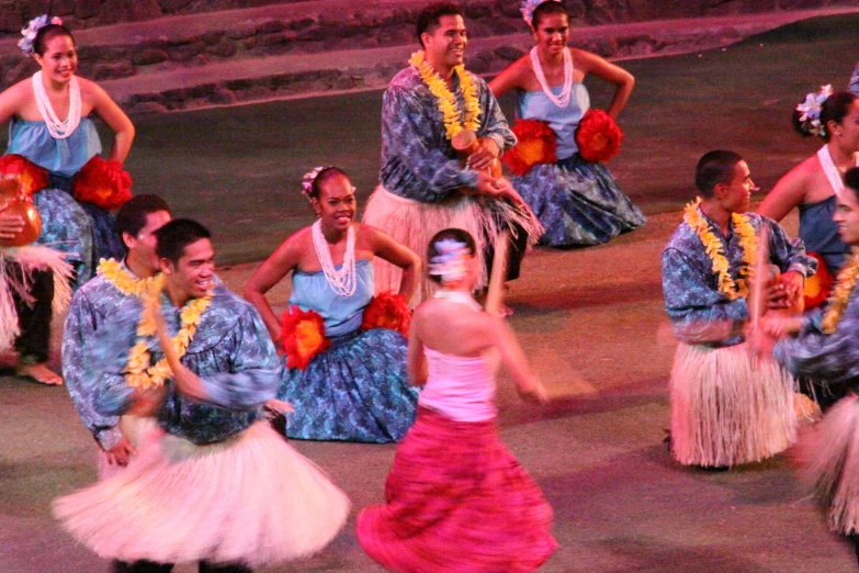many hawaiian dancers dancing around during a carnival