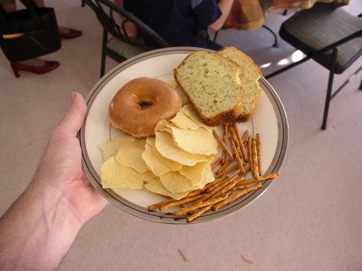 plate with sandwich and chips on it sitting on a table