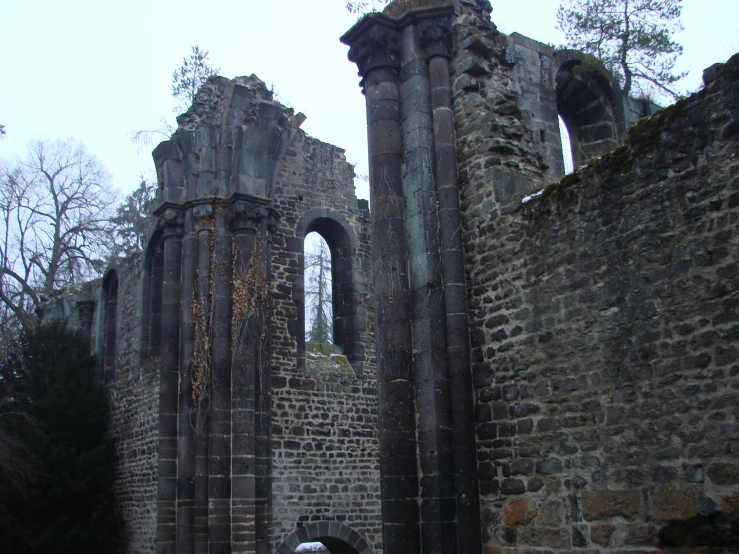 a group of tall brick structures with stone columns