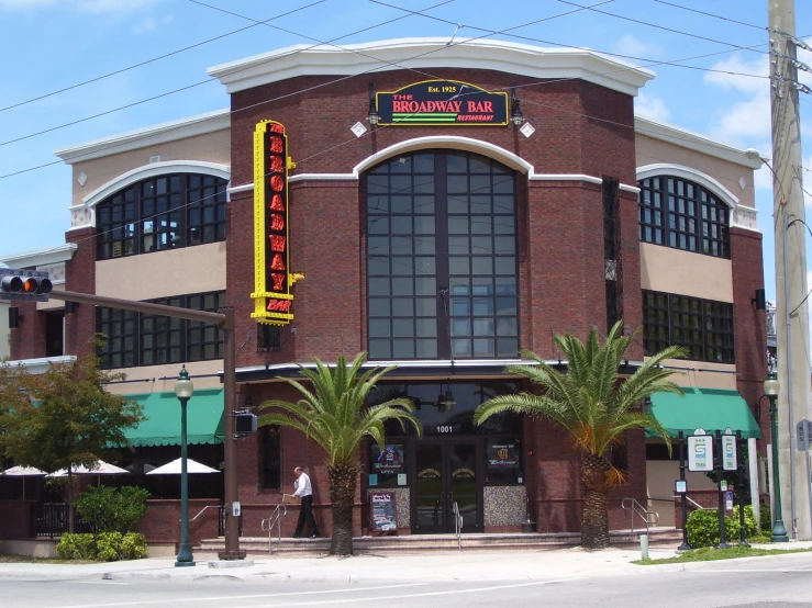 the outside of a bar with a tall sign on the front