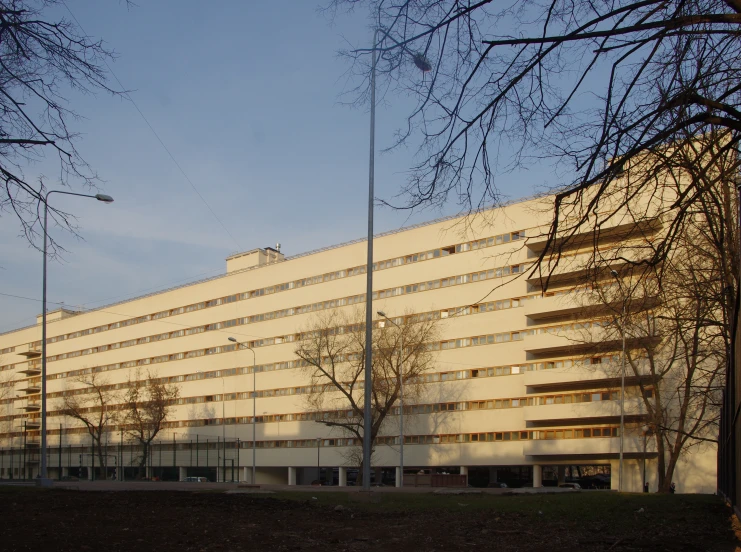 a white building that has some trees near it