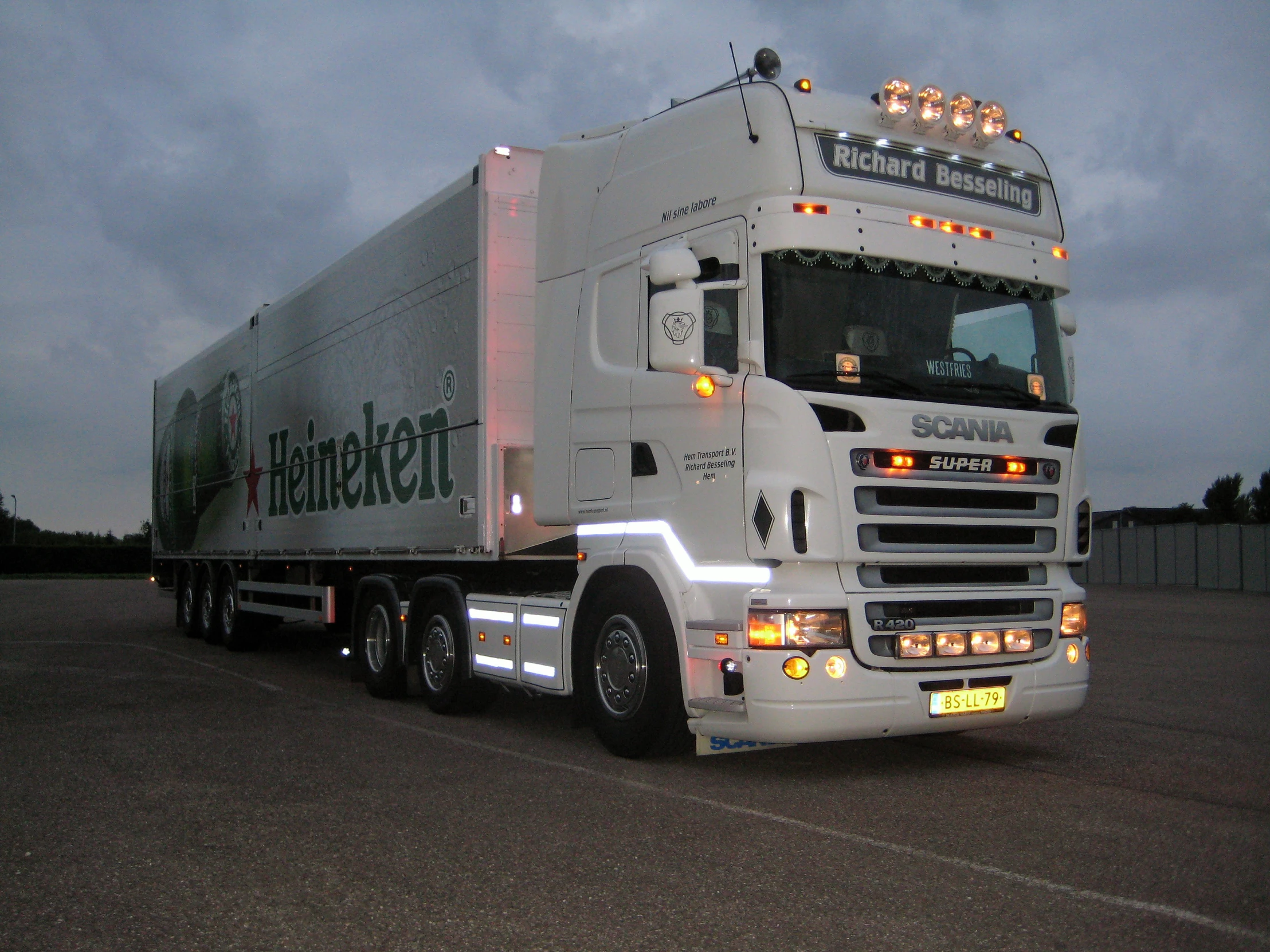 a white tractor trailer truck on a road