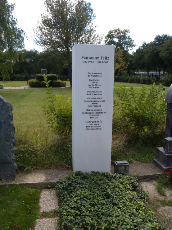 there is a sign in the middle of the cemetery