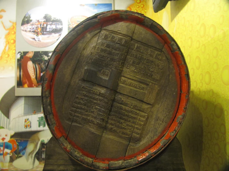 a large wooden barrel on display with a picture on it