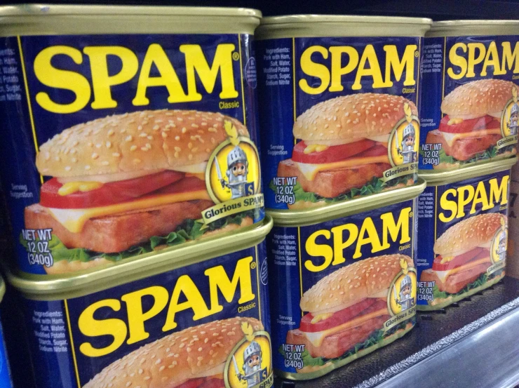 spam breaded ham wrapped in mayonnaise and lettuce sits on a shelf