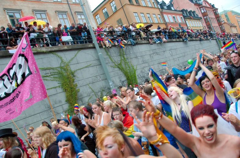 a group of people who are standing near a fence