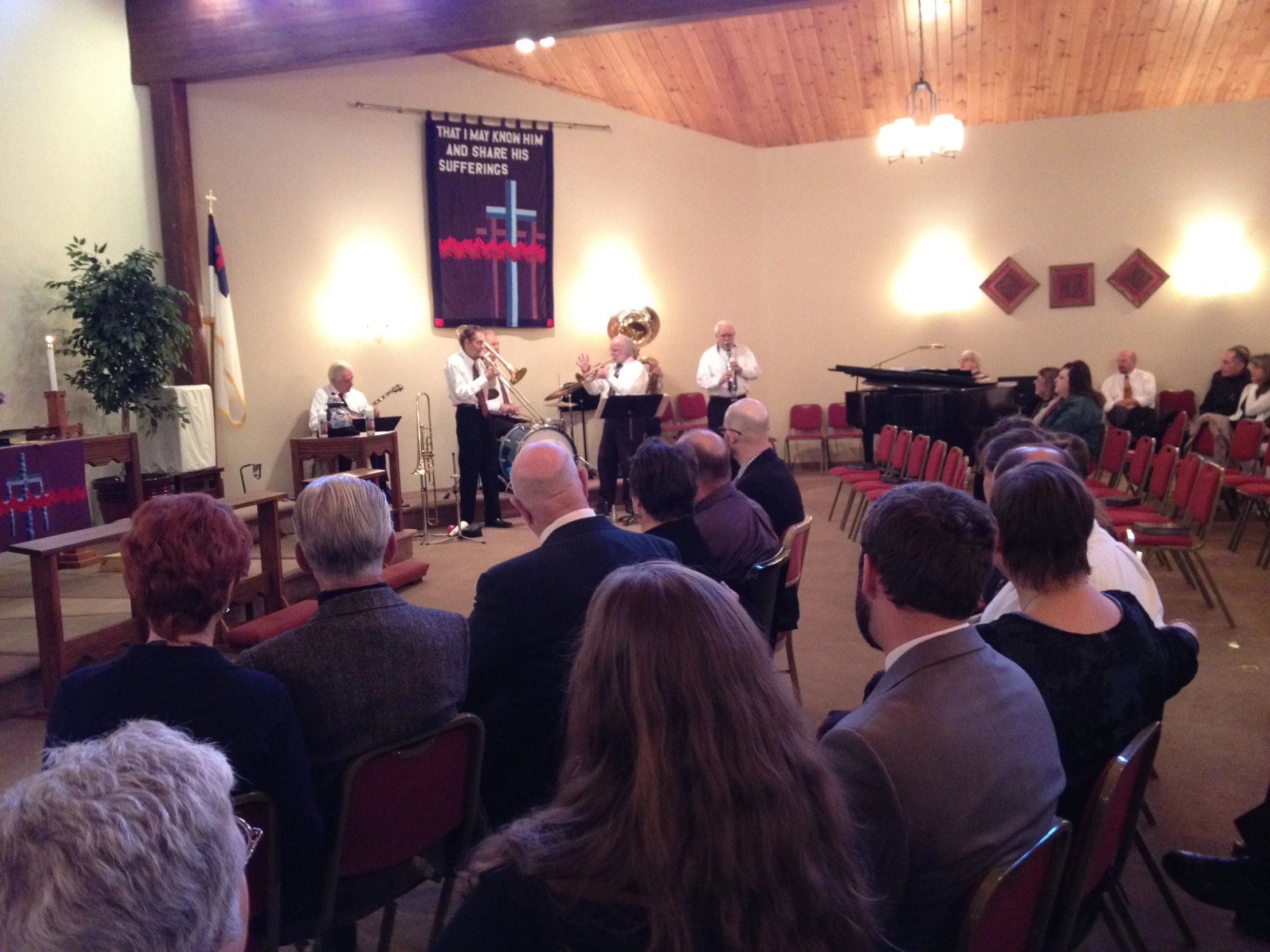 a concert of a group with people in chairs