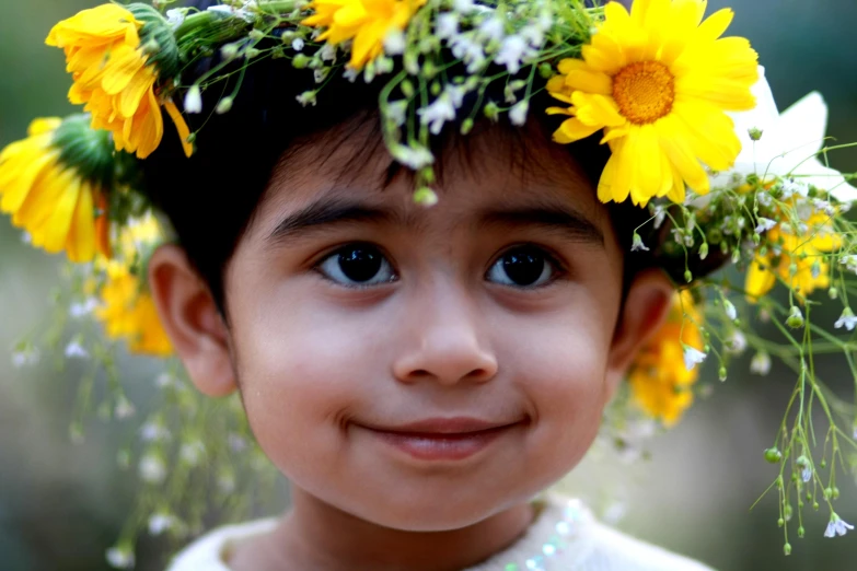 a boy with flower crowns smiles for the camera