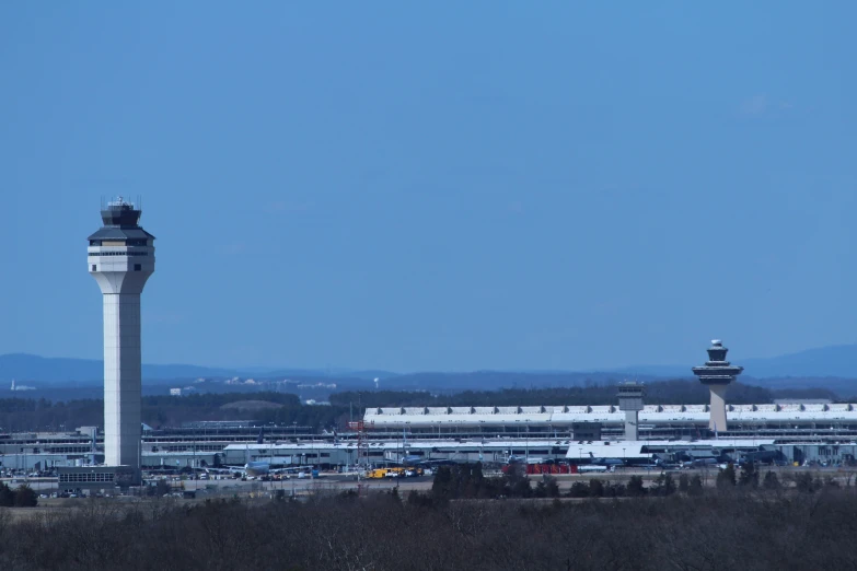 an airport terminal with a jet airliner and tower