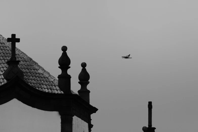 a jet flying over a building in the distance