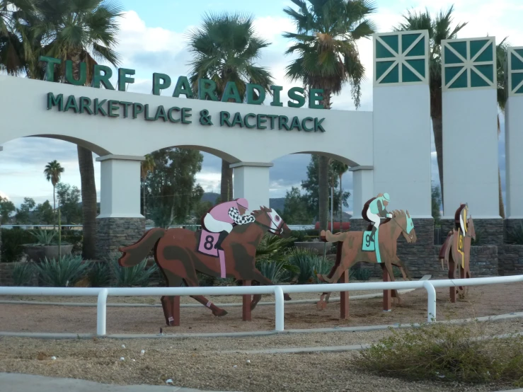 a horse sculpture stands outside the racetrack at the fair grounds