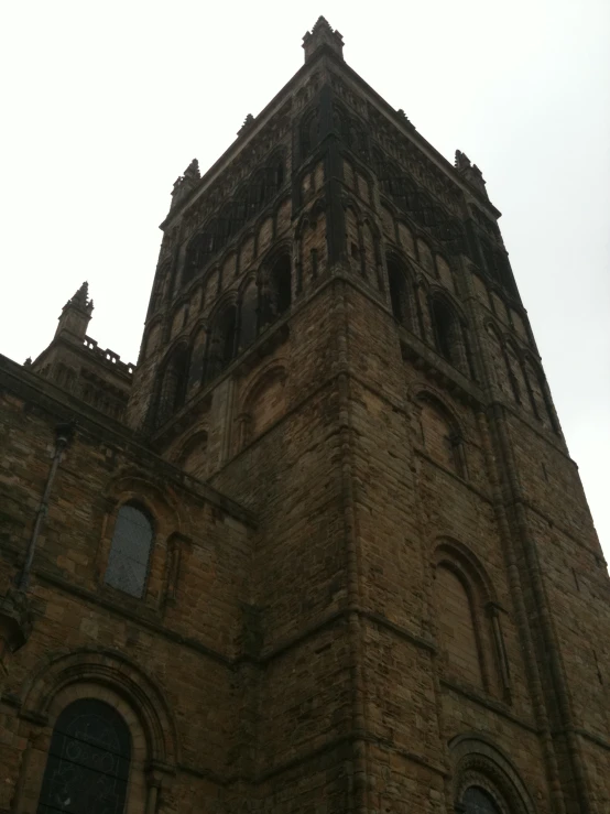 the top of a church tower against a cloudy sky