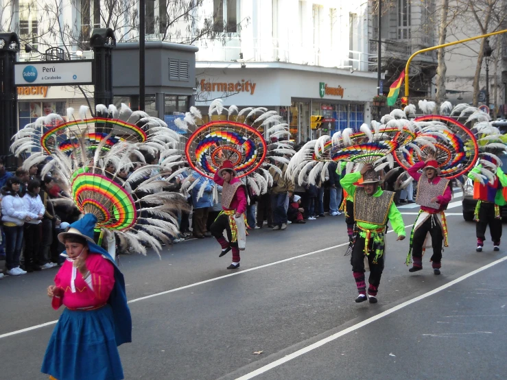 a number of people in a parade with float costumes