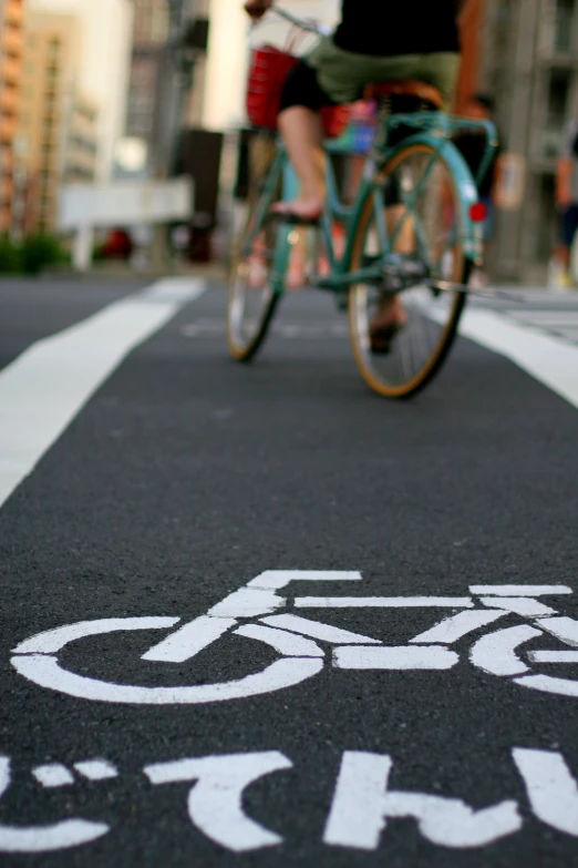 a person riding a bike down the street