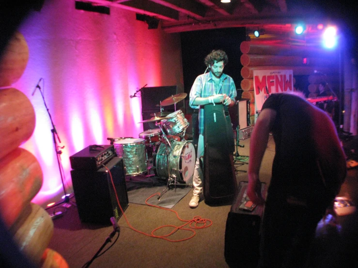 three men are on stage playing music together